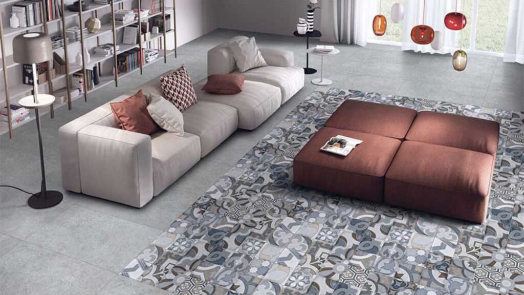 A stylish living room showcasing premium Kajaria Tiles with a marble finish on the floor and textured tiles on the accent wall, highlighting modern interior design.